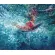 Девушка-серфингист на своей доске вырывается из накрывшей её волны на поверхность океана Художник Нина Дивинская (Волгоград)